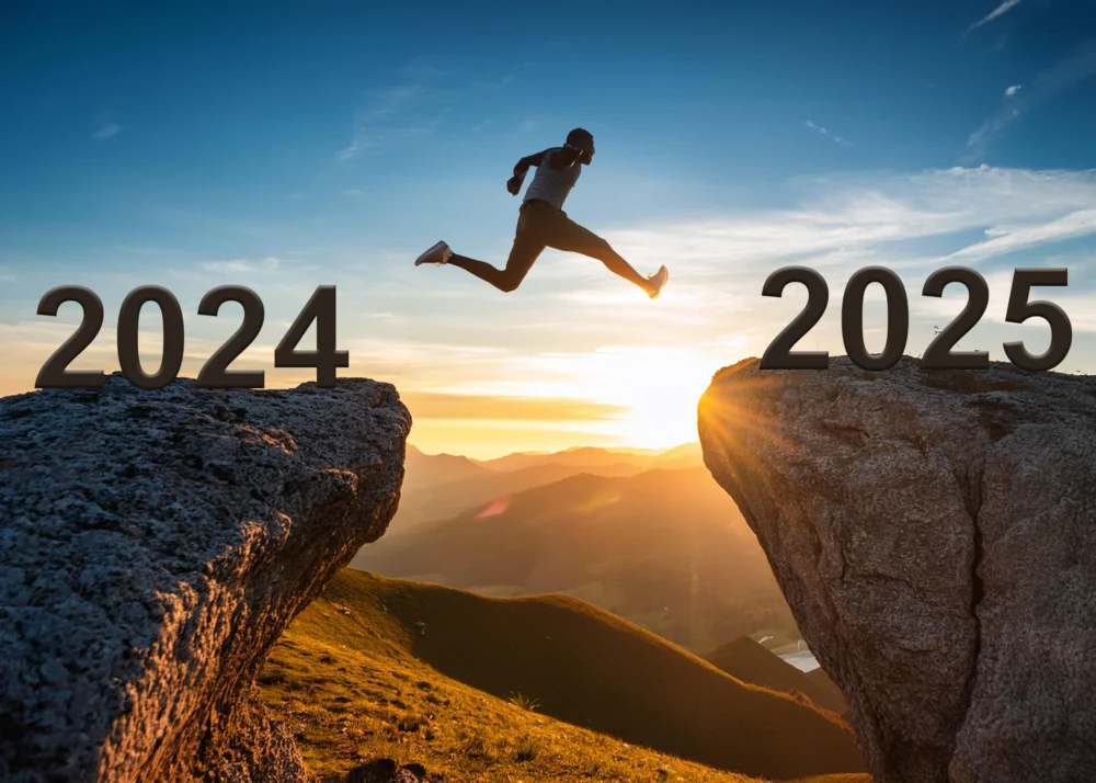 Man jumping from 2024 to 2025 year over the hill